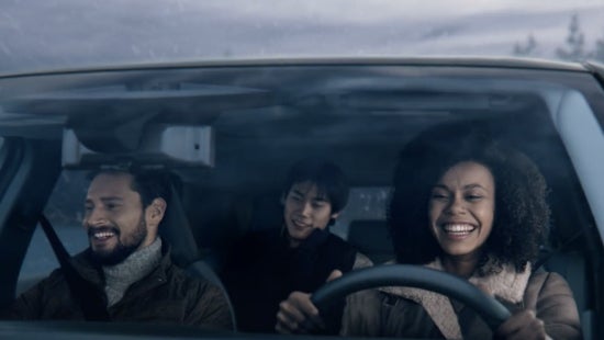 Three passengers riding in a vehicle and smiling | Mentor Nissan in Mentor OH