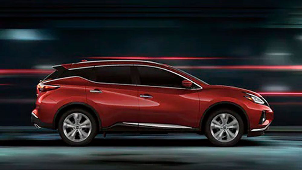 2023 Nissan Murano shown in profile driving down a street at night illustrating performance. | Mentor Nissan in Mentor OH